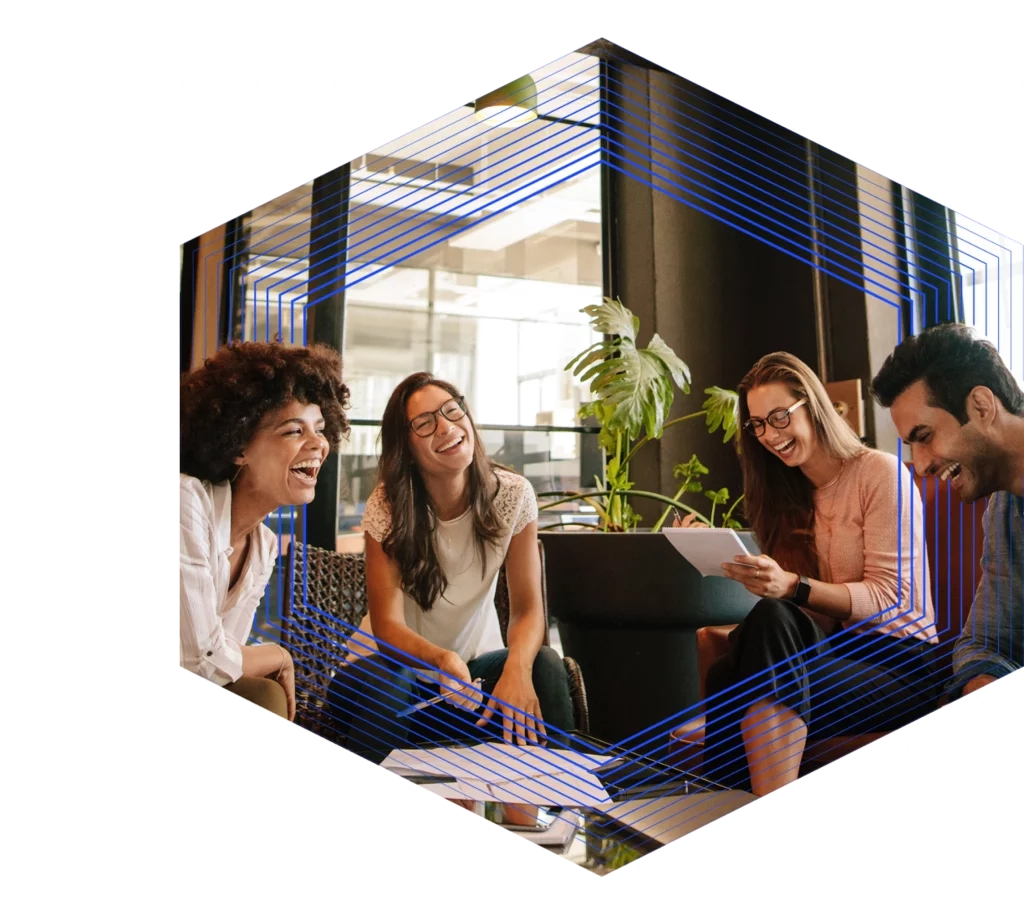 Group of women and men facing each other laughing while sitting in chairs
