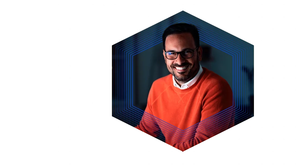 Woman wearing a yellow hard hat and safety glasses holding a tablet