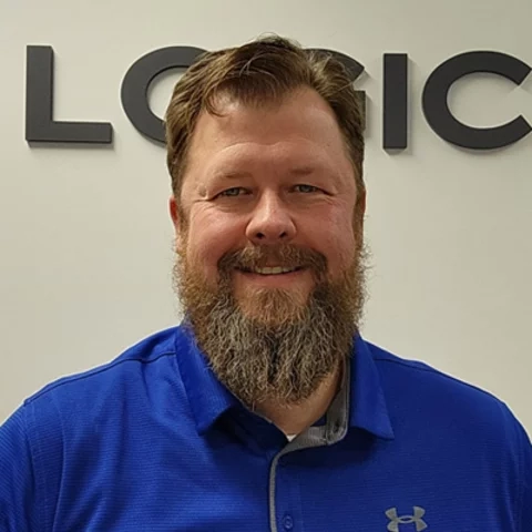 Man smiling wearing a suite and tie outside